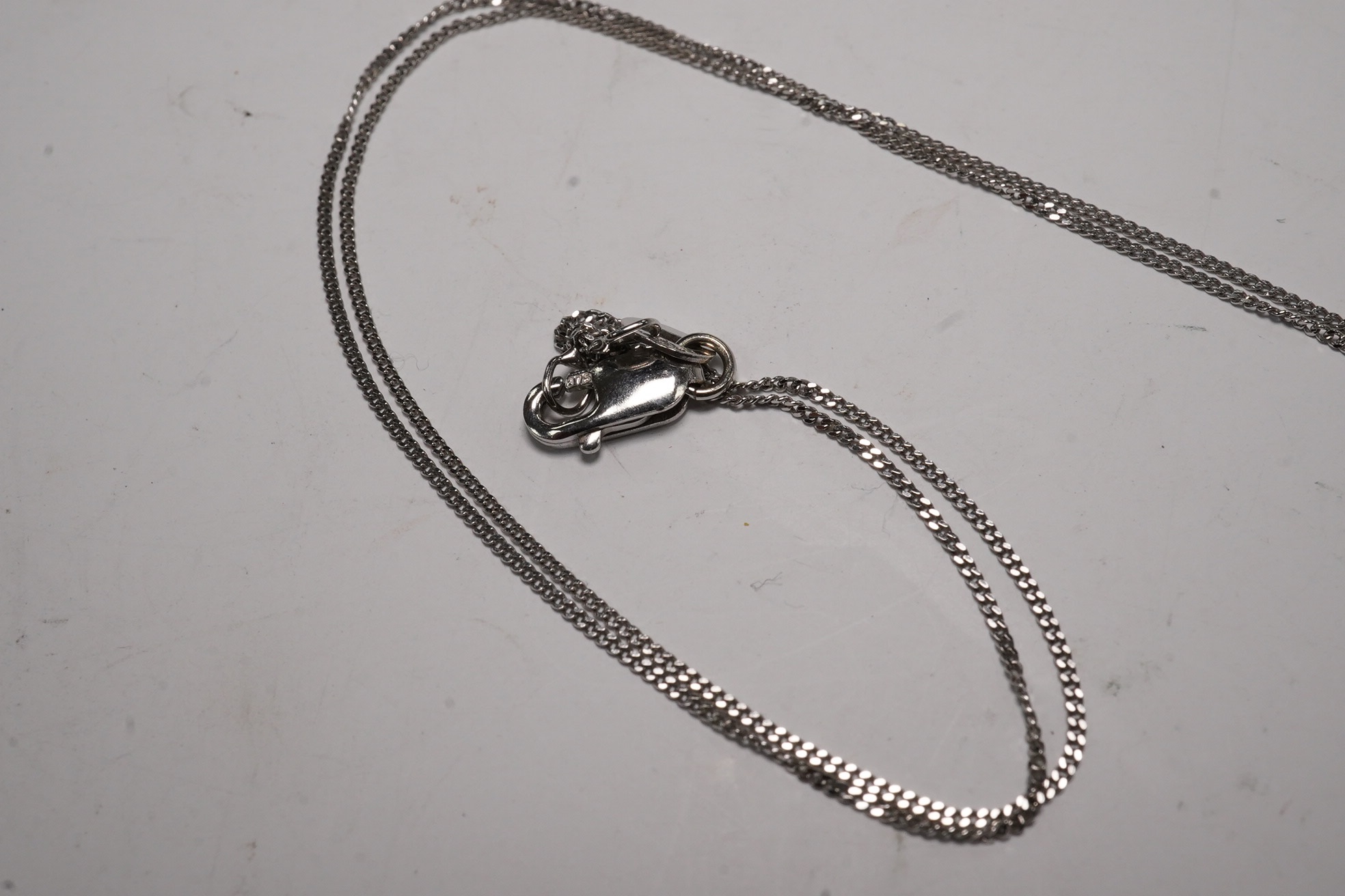 A modern 18k and diamond cluster set open work heart pendant, 25mm, a 9ct white gold and diamond chip set circular pendant necklace and o 9ct and Tahitian cultured pearl set pendant. Condition - fair to good